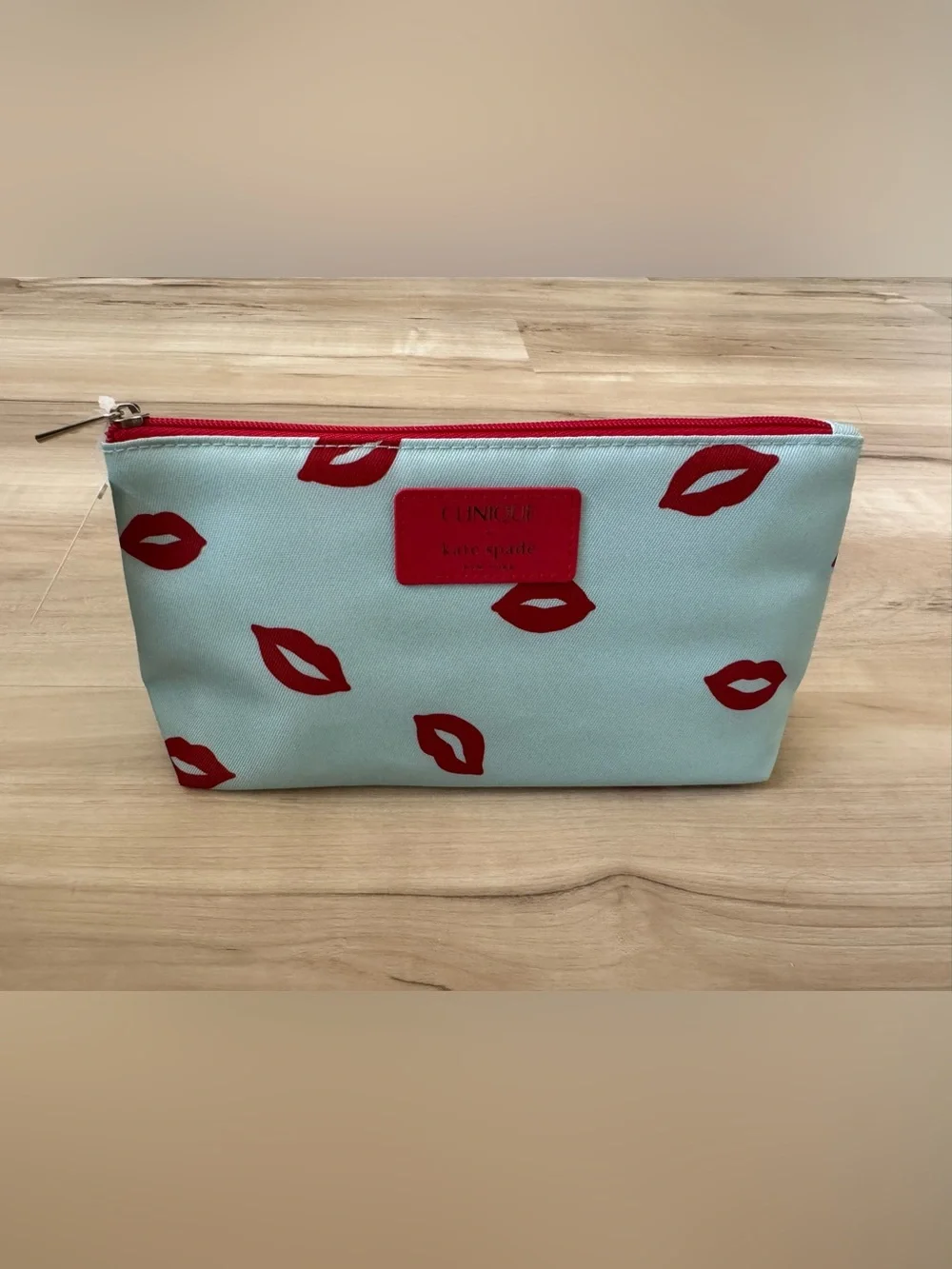Clinique x kate spade Cosmetic Pouch in Light Blue with Red Lip Print